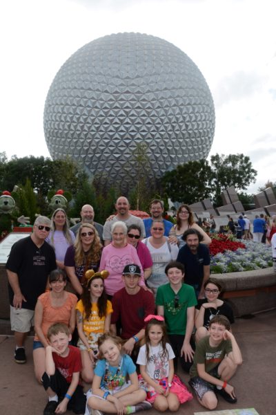 Large Family Photo In Front Of Spaceship Earth
